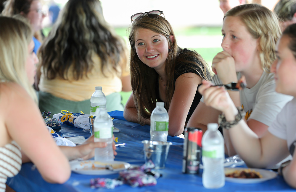 UNK incoming freshman Meg Schluns, center, chats with her new roommates and a Fraternity and Sorority Life member at a UNK Hangout Thursday at Harmon Park. 