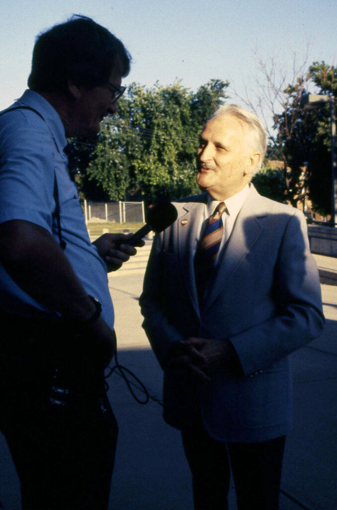 William Nester, right, speaks to a reporter during a campus celebration on July 1, 1991, when Kearney State College officially joined the University of Nebraska system. Nester led the transition as president of Kearney State College before becoming the first chancellor of UNK.