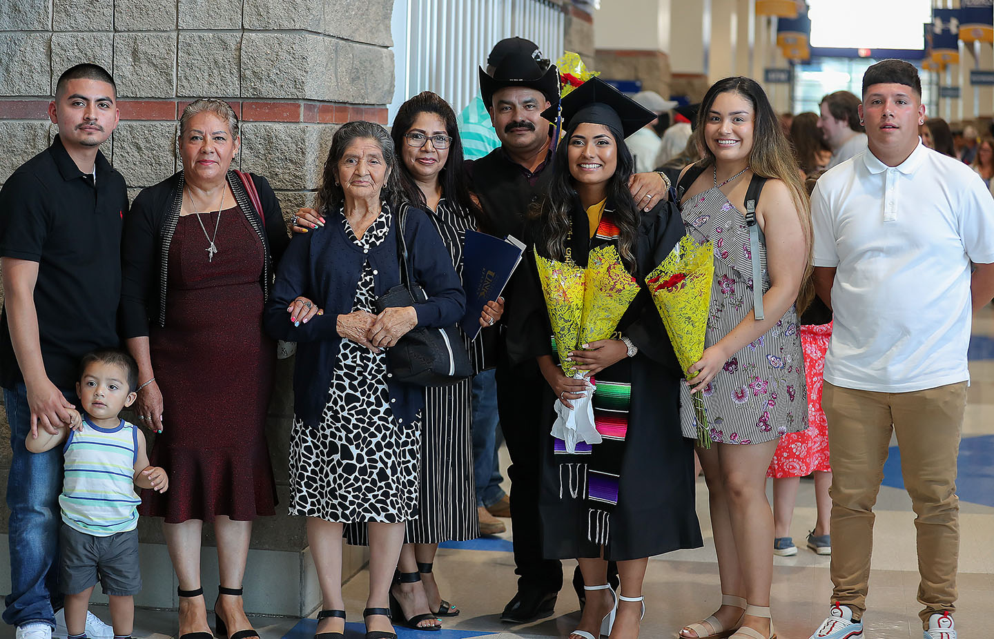 Edna Medina, third from right, poses for a photo with her family following Friday’s summer commencement ceremony at UNK’s Health and Sports Center.