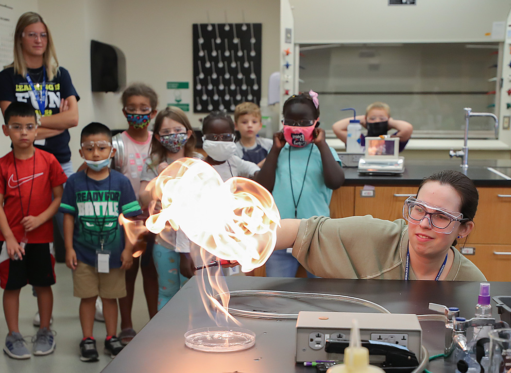 Karen Batchelder, a laboratory and instrument technician in the UNK Department of Chemistry, conducts a science experiment for students attending the PAWS University Prep Academy. That week’s theme was fire.