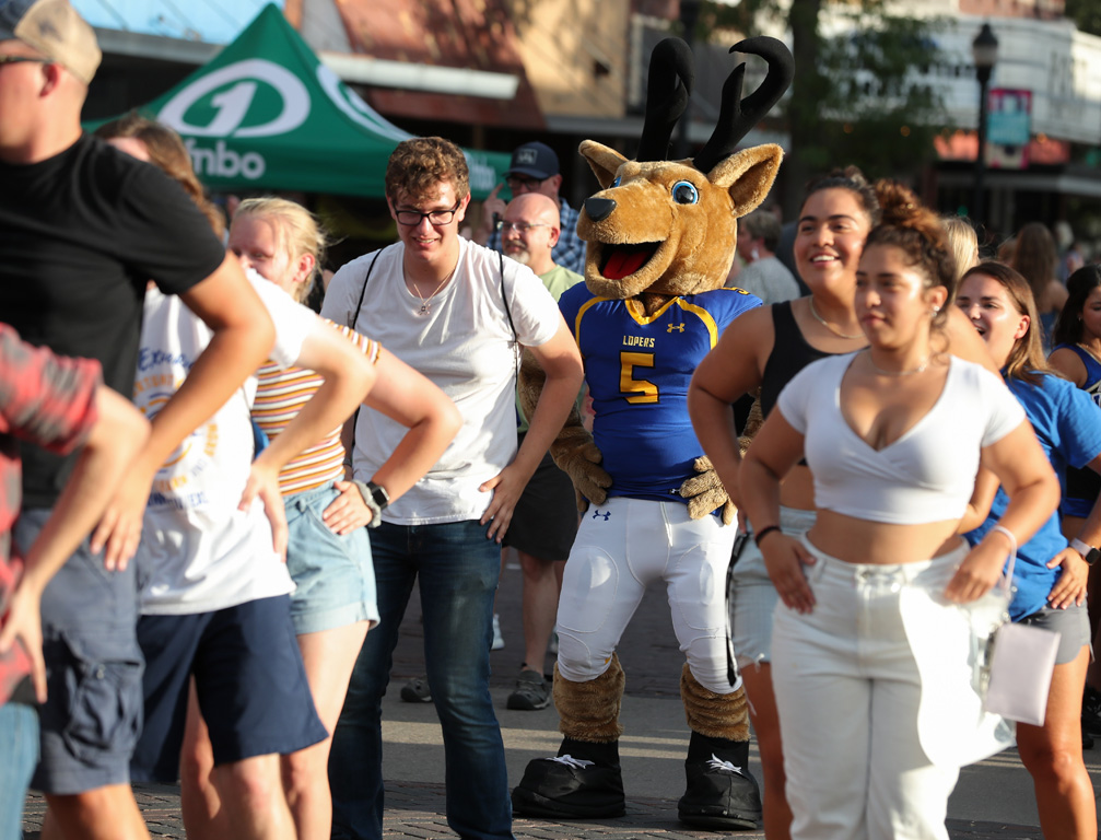 Louie the Loper joins a group of UNK students dancing to “Macarena” on Thursday evening during Destination Downtown. (Photos by Erika Pritchard, UNK Communications)