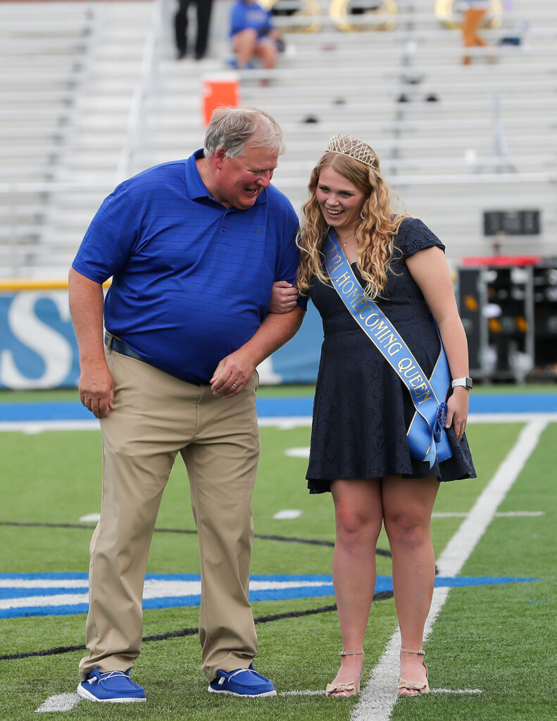 UNK Chancellor Doug Kristensen jokes with Holly Rockenbach during halftime of the Oct. 9 football game at Cope Stadium. Rockenbach was recognized as homecoming queen.