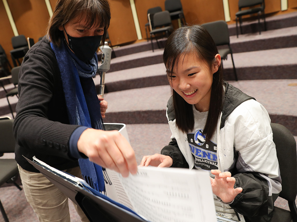 UNK lecturer Franziska Brech, left, introduces Ravenna High School junior Kaia Johnson to a new musical piece Thursday afternoon during the first-ever UNK Music Day.