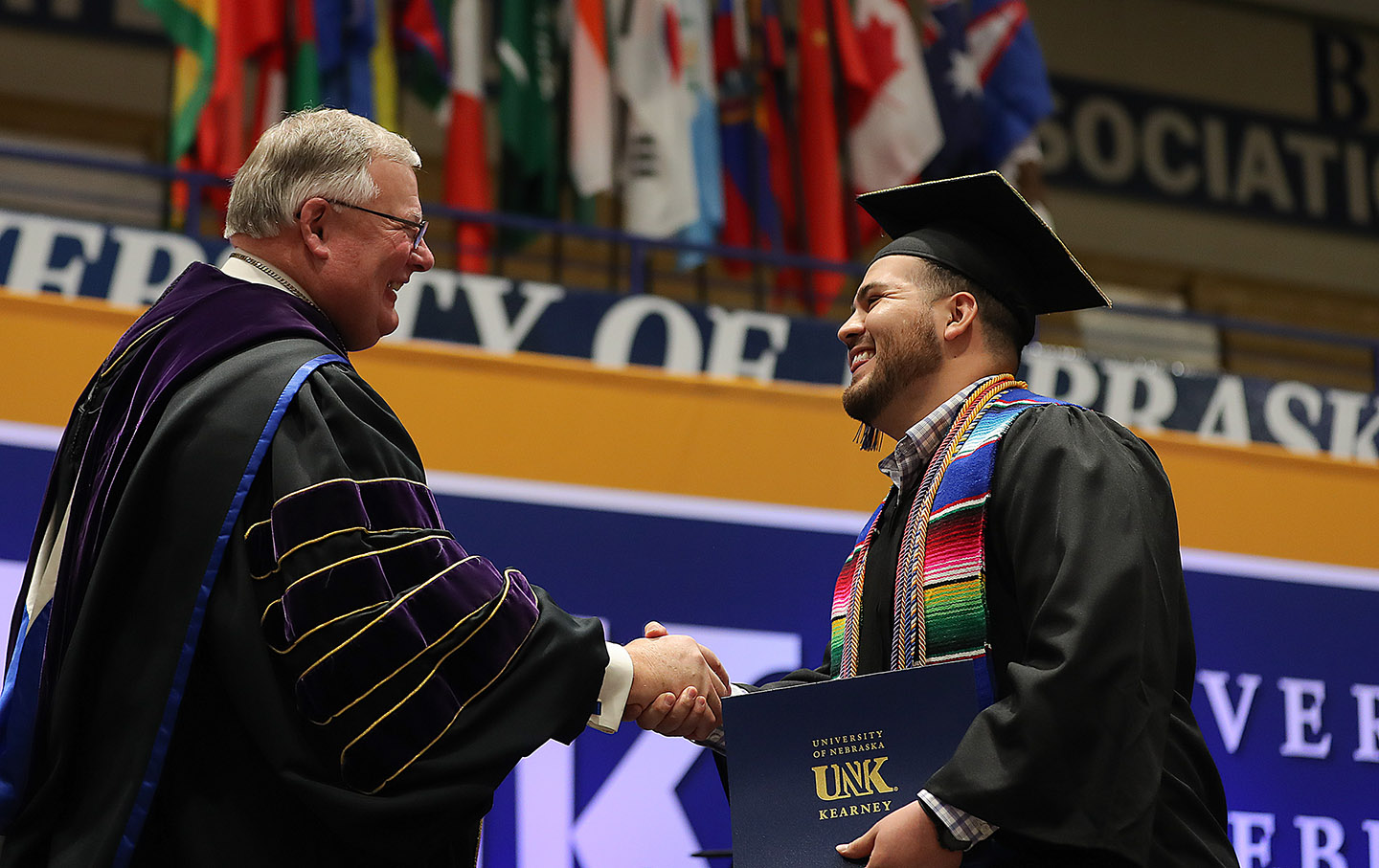 Jose Ceballos, right, is congratulated by UNK Chancellor Doug Kristensen during Friday’s winter commencement ceremony. Ceballos received bachelor’s degrees in modern languages education and English as a second language. (Photos by Erika Pritchard, UNK Communications)
