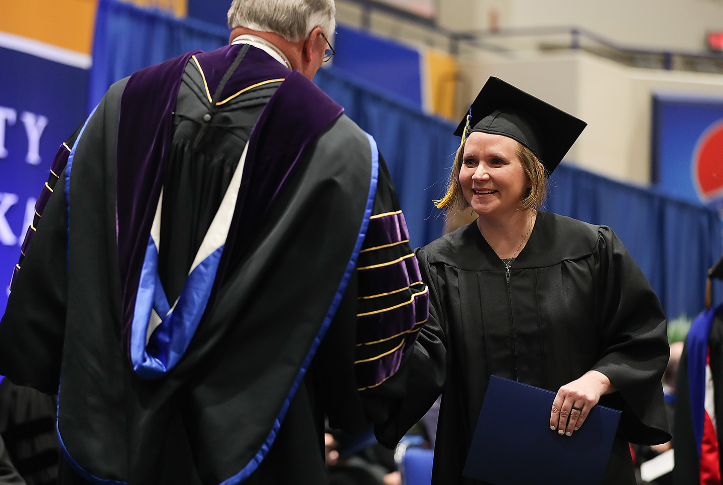 Kimberley Orcutt receives her bachelor’s degree from UNK Chancellor Doug Kristensen during Friday’s winter commencement ceremony. Orcutt started taking classes nine years ago while continuing to work full time at UNK. (Photos by Erika Pritchard, UNK Communications)