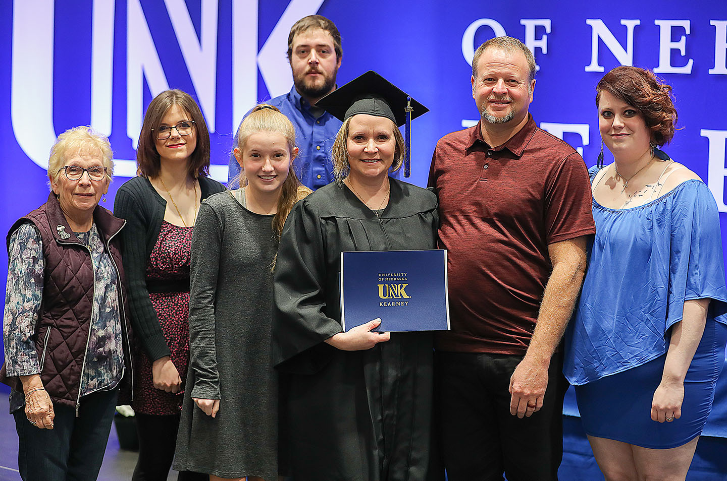 UNK employee Kimberley Orcutt poses for a photo with her family following Friday’s winter commencement ceremony. Orcutt earned a bachelor’s degree in business administration with a management emphasis.