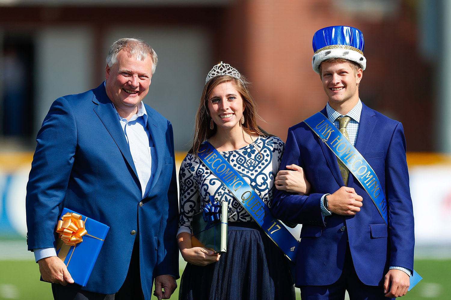 Logan Krejdl, right, was voted UNK homecoming king in fall 2017. He’s pictured with UNK Chancellor Doug Kristensen and 2017 homecoming queen Miranda Ketteler.