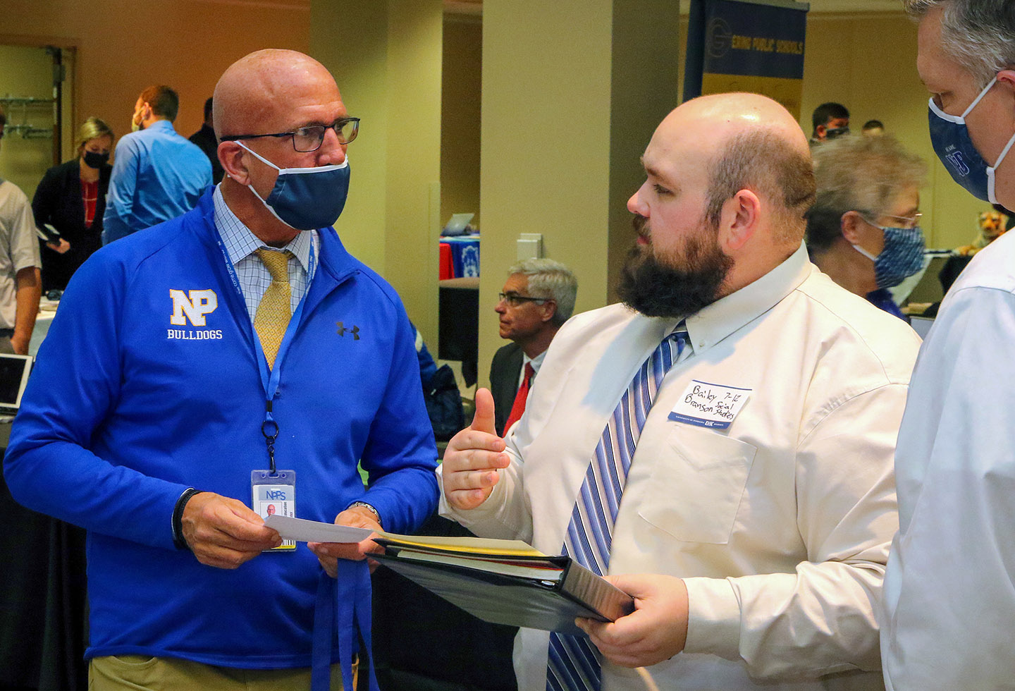 UNK senior Bailey Branson, middle, meets with Kevin Mills, left, director of human resources at North Platte Public Schools, during Thursday’s Education Opportunities Fair.