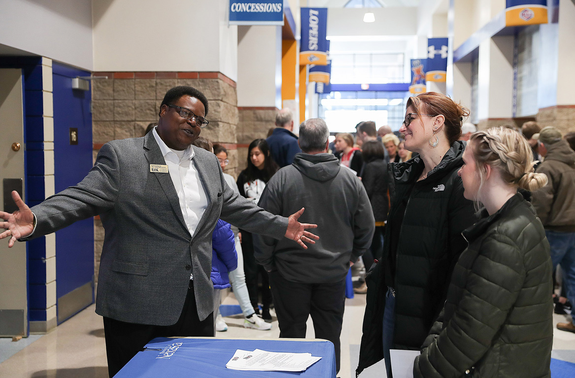 Rashawn Harvey, assistant director of TRIO Student Support Services, left, meets with a family Tuesday during Admitted Student Day at UNK.