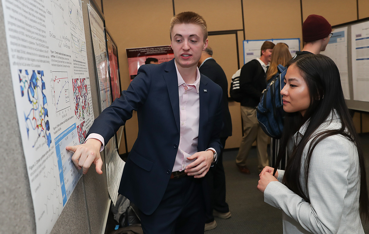 UNK junior Zach Zavodny, left, presents his research Thursday during the Research Day celebration on campus. (Photos by Erika Pritchard, UNK Communications)