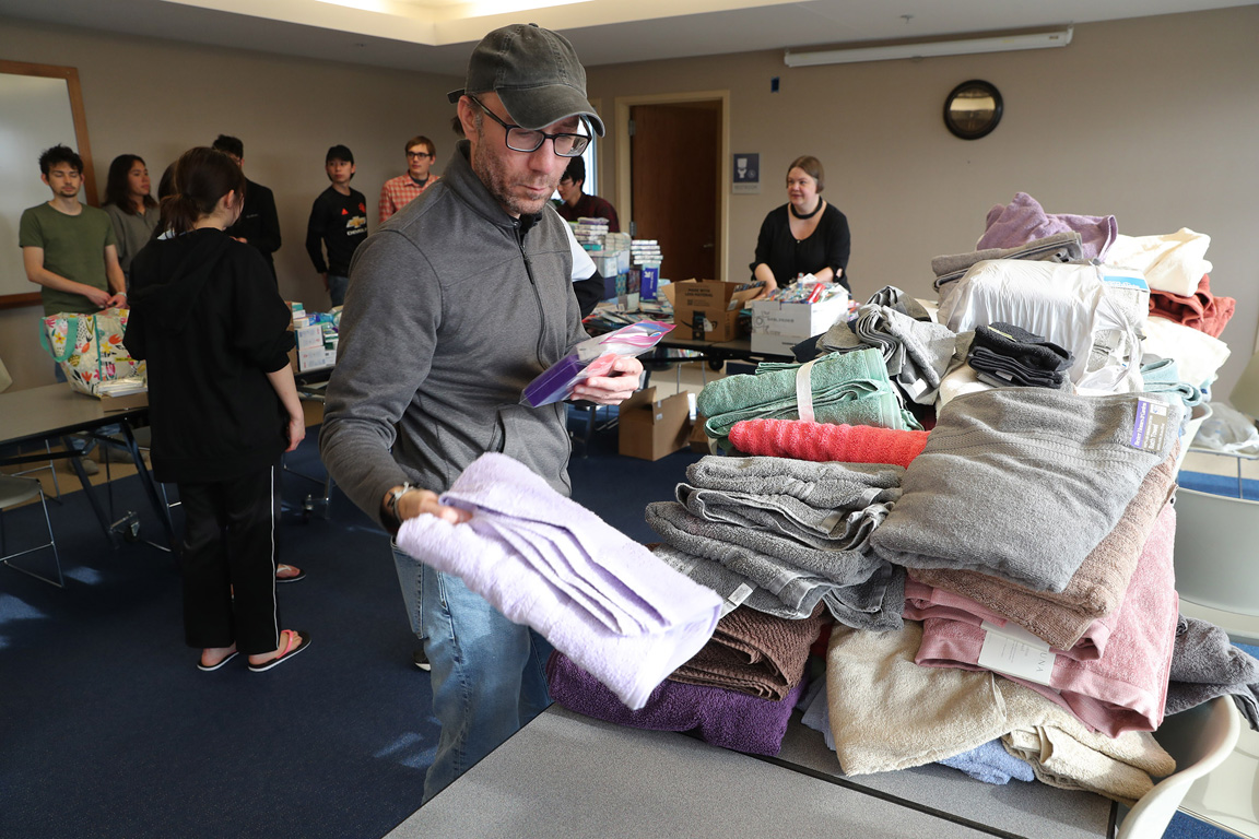 UNK political science professor Will Aviles helps assemble hygiene kits for Ukrainian refugees during a student-led service project on campus. (Photos by Erika Pritchard, UNK Communications)