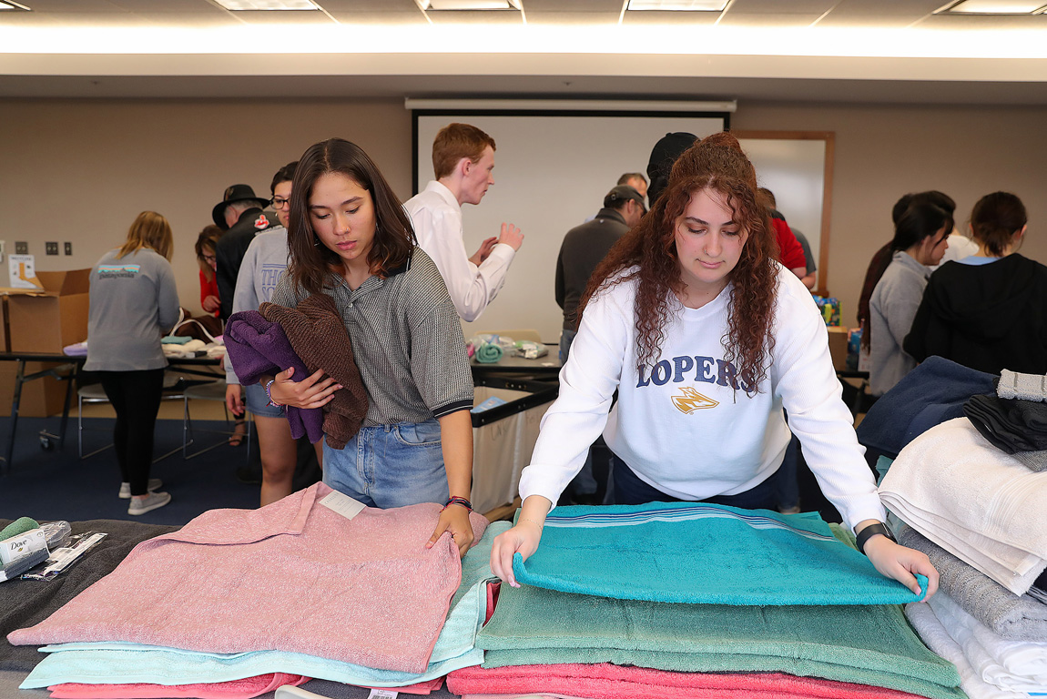 From left, UNK sophomore Melisa Becerra of Colombia and junior Emily Saadi of Kearney organize donations Thursday evening during a student-led service project supporting Ukrainian refugees.