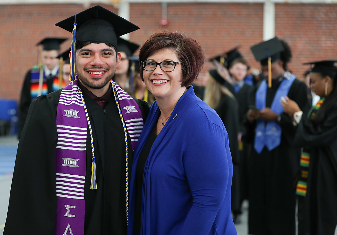 UNK spring graduate Giovanni Flores poses with Thompson Scholars Learning Community Director Jennifer Harvey before commencement earlier this month. Harvey helped Flores get back into the program this year.