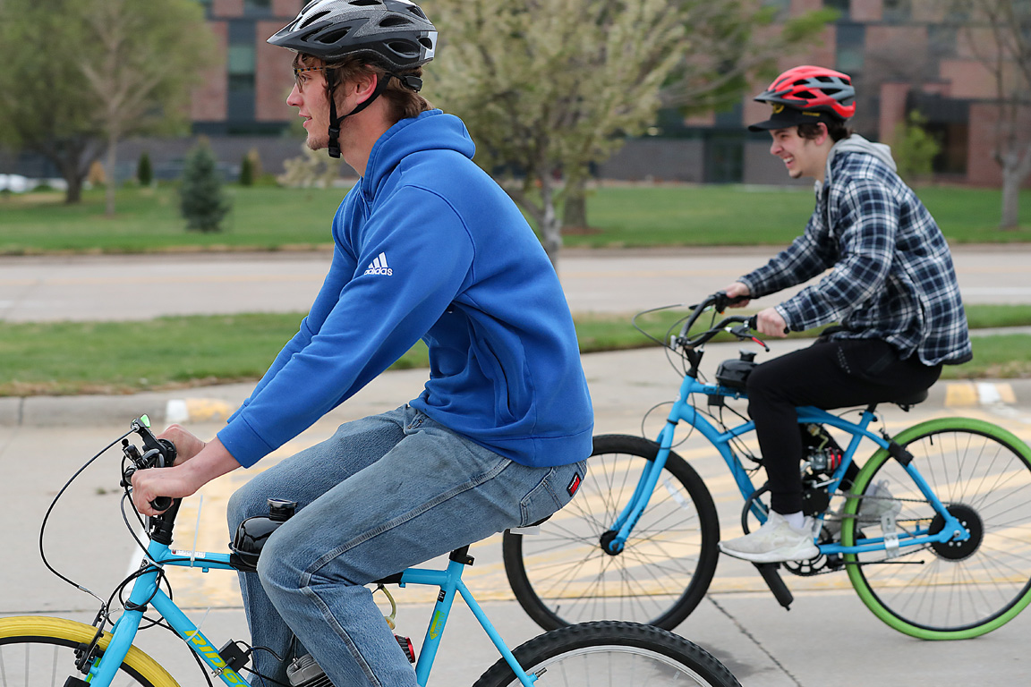 UNK junior Jack Sutton of Wahoo speeds toward the finish line ahead of junior Jayden Paul of Kearney during last week’s motorized bike race on campus. Students built the bikes in an industrial distribution class. (Photos by Erika Pritchard, UNK Communications)