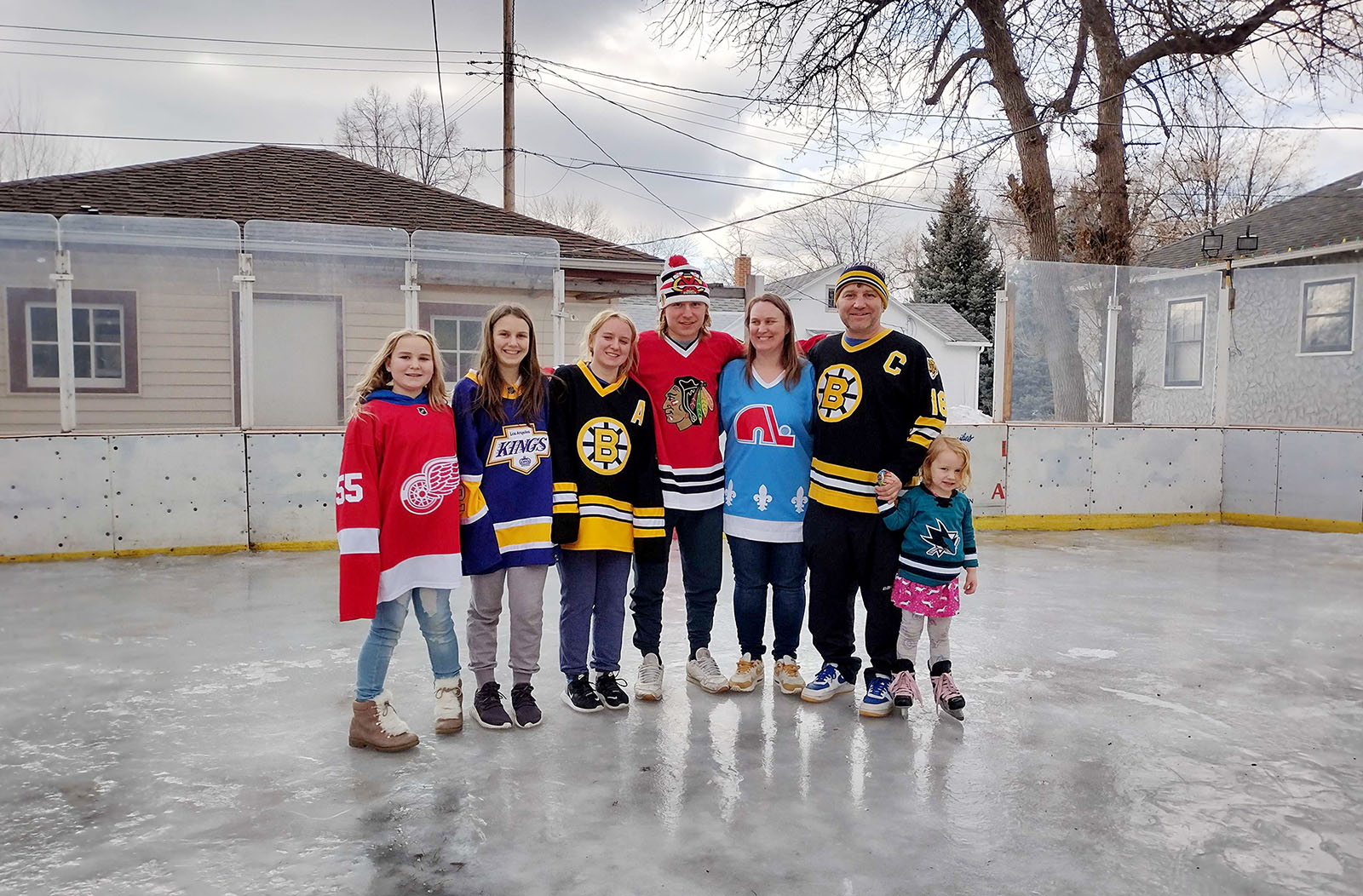 Thomas Orr and his family pose for a photo on the hockey rink he built at their home in Aberdeen, South Dakota. (Courtesy photo)