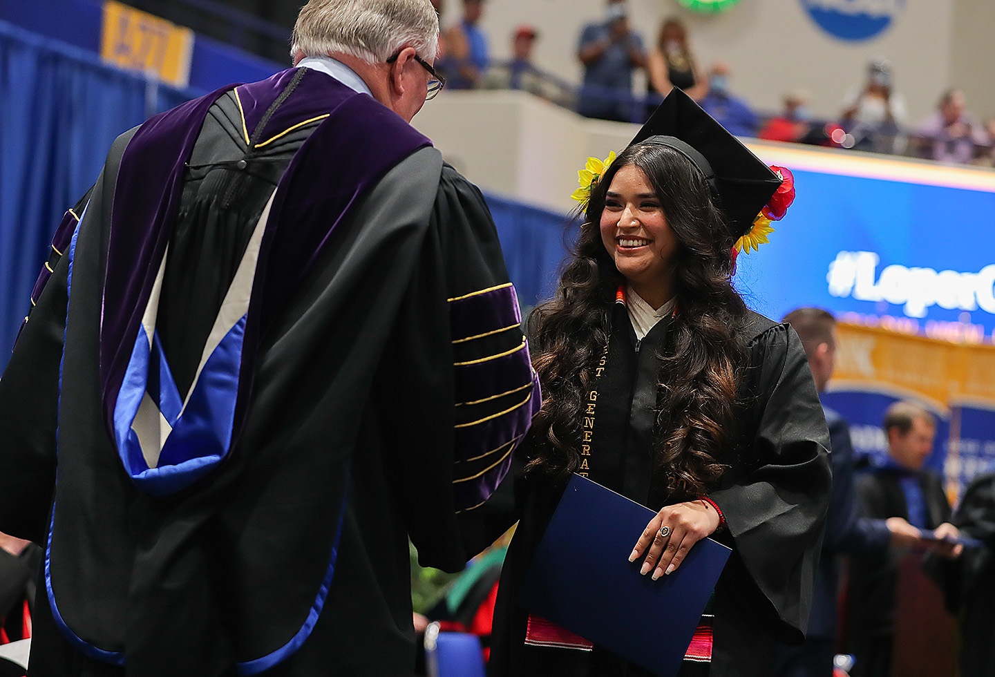 UNK Chancellor Doug Kristensen congratulates graduate Guadalupe Maravilla of Lexington during Friday’s spring commencement ceremony in the Health and Sports Center. Maravilla earned a bachelor’s degree in health sciences.
