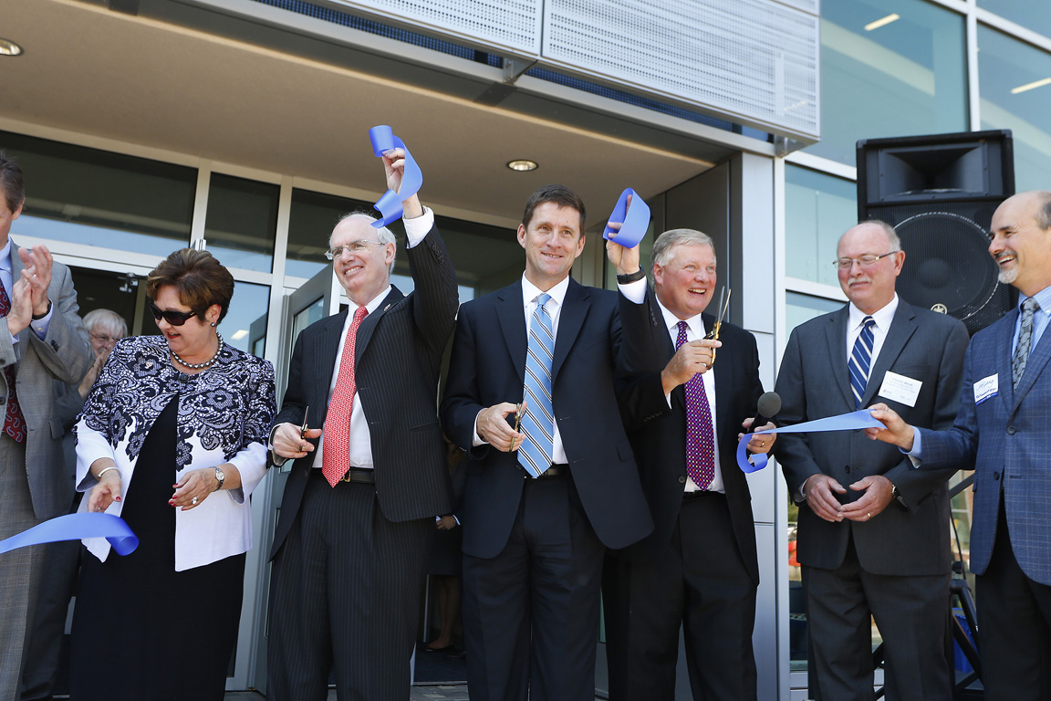 Charlie Bicak, second from right, and Doug Kristensen, third from right, are pictured during a ribbon-cutting ceremony for the Health Science Education Complex in August 2015.
