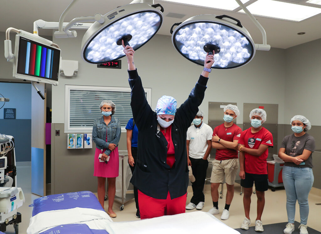 Lexington Regional Health Center surgical technologist Ashley Bartlett, center, shows off the surgical lights in one of the hospital’s operating rooms to University of Nebraska at Kearney Diversity in Health Care campers Monday morning. The students toured the Lexington facility and learned about different health care fields at the one-day camp.