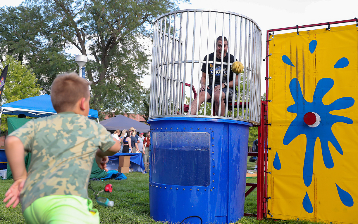 David Vail, associate professor of history at UNK, has a good time in the dunk tank during Blue and Gold Showcase.