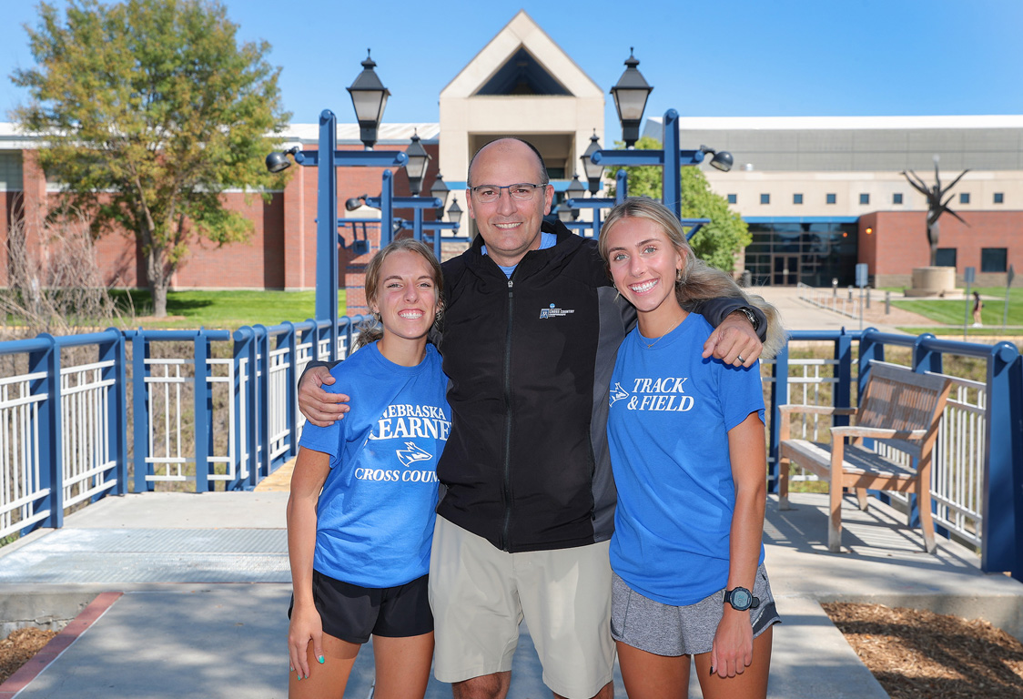 Brady Bonsall coaches his daughters Emma, left, and Grace on the UNK cross country and track and field teams.