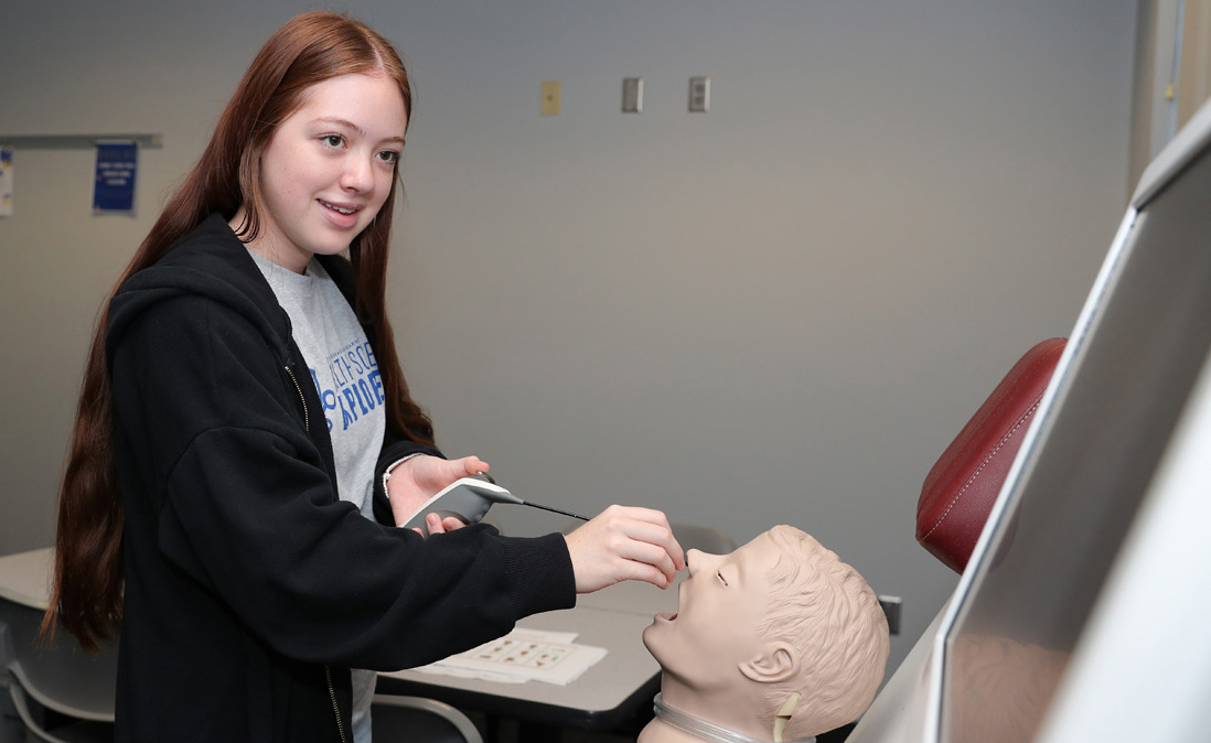 Kearney High School senior Emily Korb participates in an activity during last week’s Health Science Explorers Academy meeting at UNK.