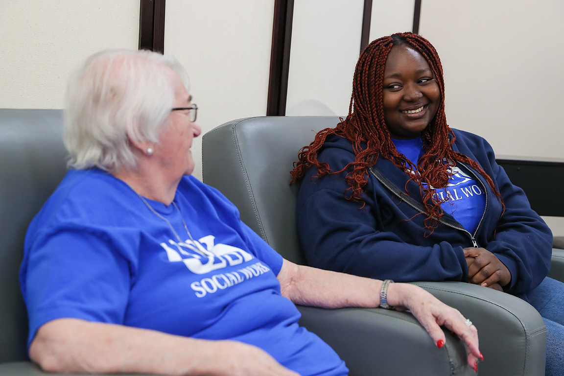 UNK social work major Esther Uma, right, chats with Kearney Manor resident Martha Tiede on Tuesday morning as part of an experiential learning project for the aging services class. (Photos by Erika Pritchard, UNK Communications)