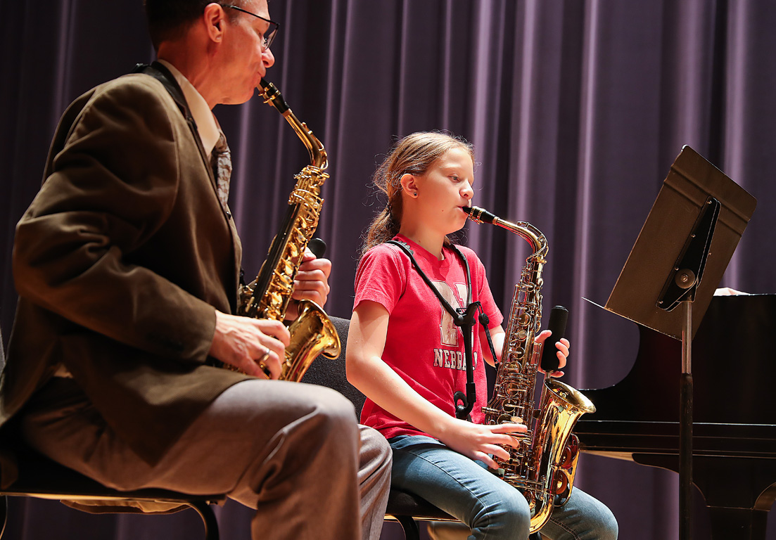 Claire Bahensky plays her one-handed saxophone with guidance from UNK music professor David Nabb during a recent trip to Kearney. (Photos by Erika Pritchard, UNK Communications)
