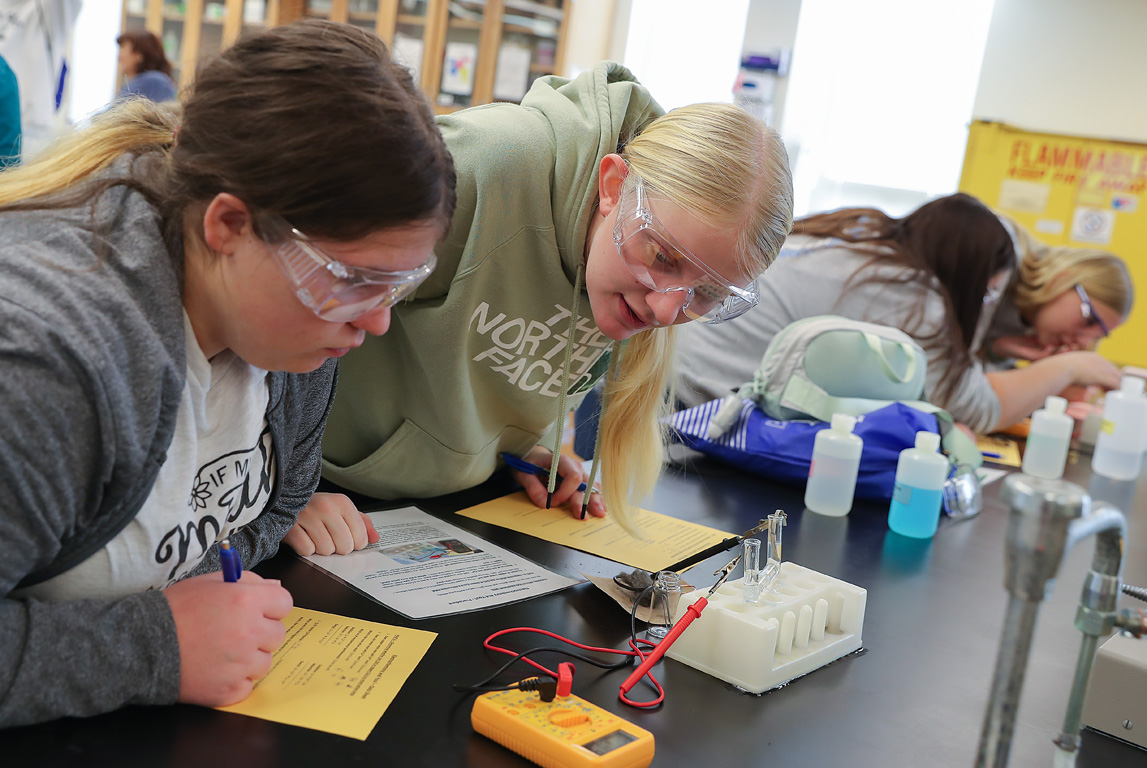 Adams Central High School senior Serese Janssen, right, conducts an electrochemistry experiment with a classmate during Science Day at UNK. Nearly 130 high schoolers from across the state attended Tuesday’s event.
