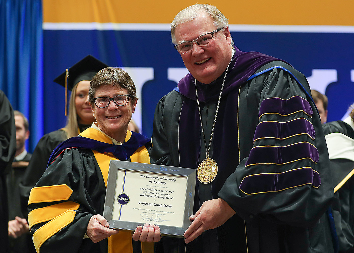 UNC Chancellor Doug Kristensen (right) presents the Leland Holdt/Security Mutual Life Distinguished Faculty Award to biology professor Janet Steele during Friday's winter celebration at the on-campus Health and Athletic Center.  (Photos by Erika Pritchard, UNK Communications)