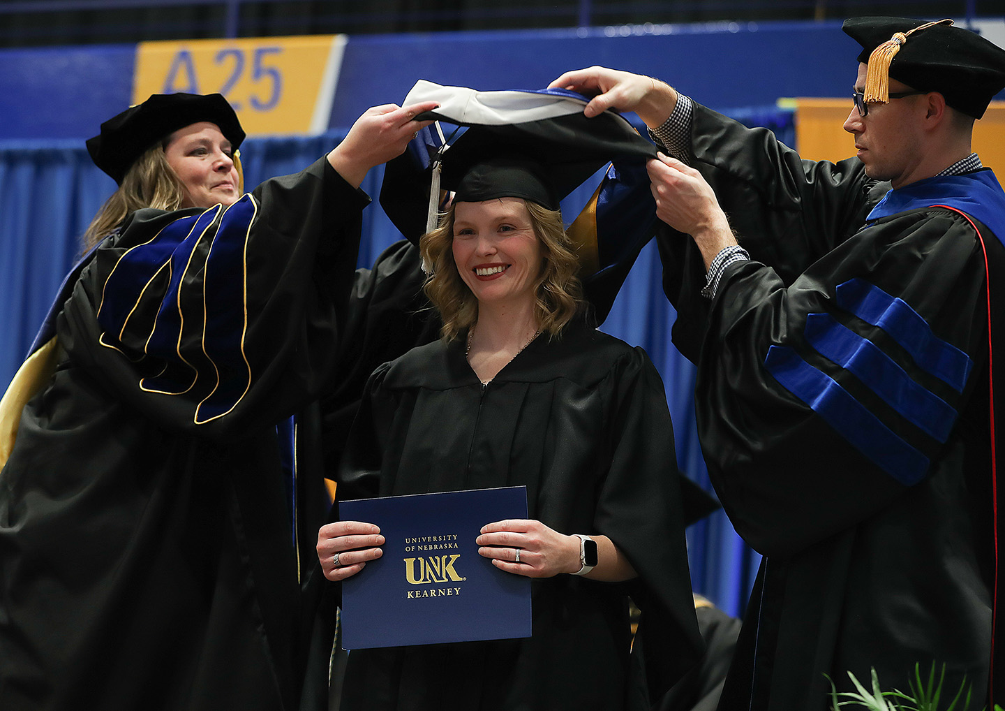 Nicole Strope, center, graduated from the University of Nebraska at Kearney last week with a master’s degree in English with a writing emphasis. It’s her third degree from UNK. (Photo by Erika Pritchard, UNK Communications)