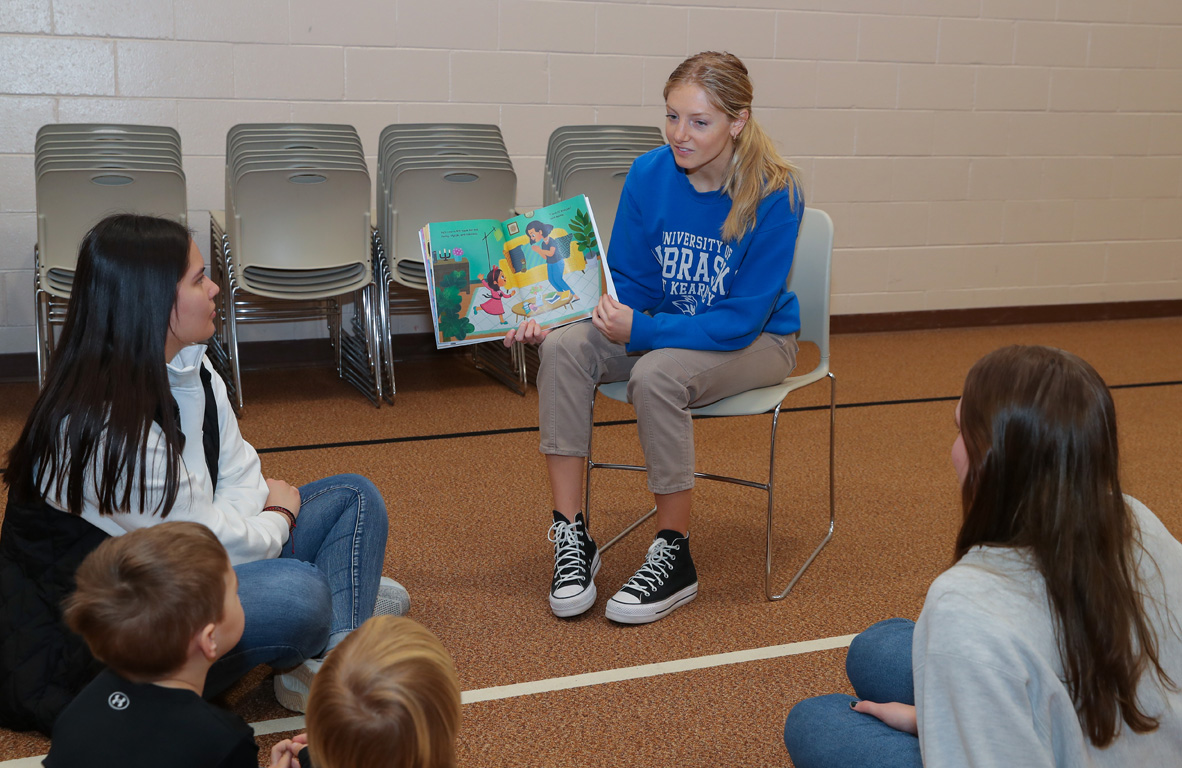UNK sophomore Brooke Glaser reads a book about healthy oral care habits to children at First Lutheran Preschool during Tuesday’s event.