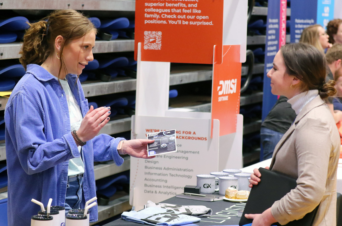 Claire Cornell, recruiting and marketing manager for GIX Logistics, left, chats with a UNK student during the Career and Internship Fair.