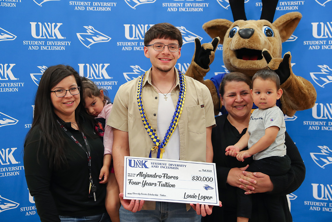 Alejandro Flores poses for a photo with his family during Thursday’s scholarship ceremony.