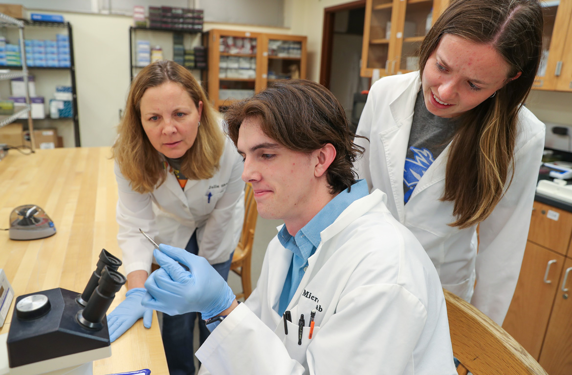 UNK biology professor Julie Shaffer, left, conducts tick research in her lab with undergraduate students Noah Shackelford and Avery Mitchell.