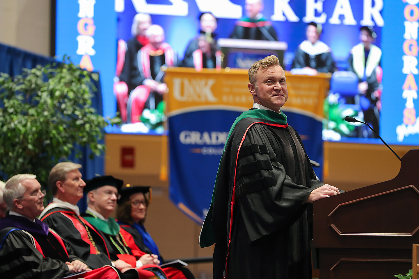 Brad Bohn speaks to graduates and other attendees May 19 during the spring commencement ceremony at UNK’s Health and Sports Center. (Photo by Erika Pritchard, UNK Communications)