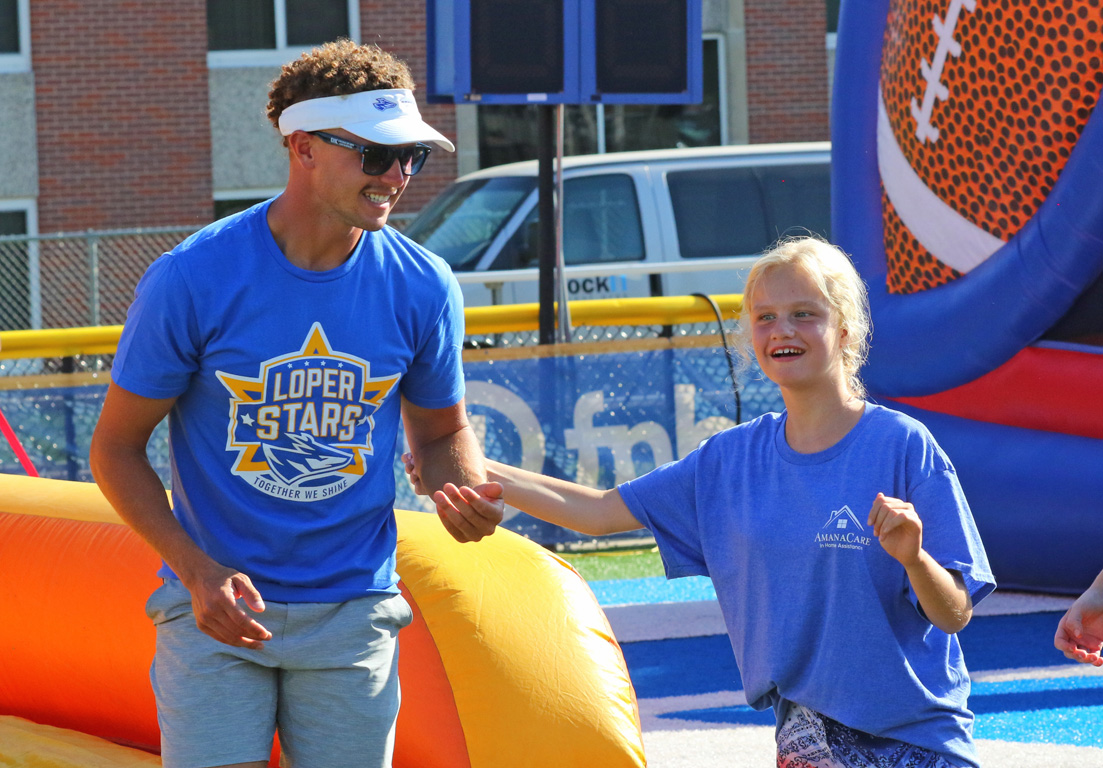 UNK football player Hunter Kraus assists with an activity during Sunday’s Loper Stars event.
