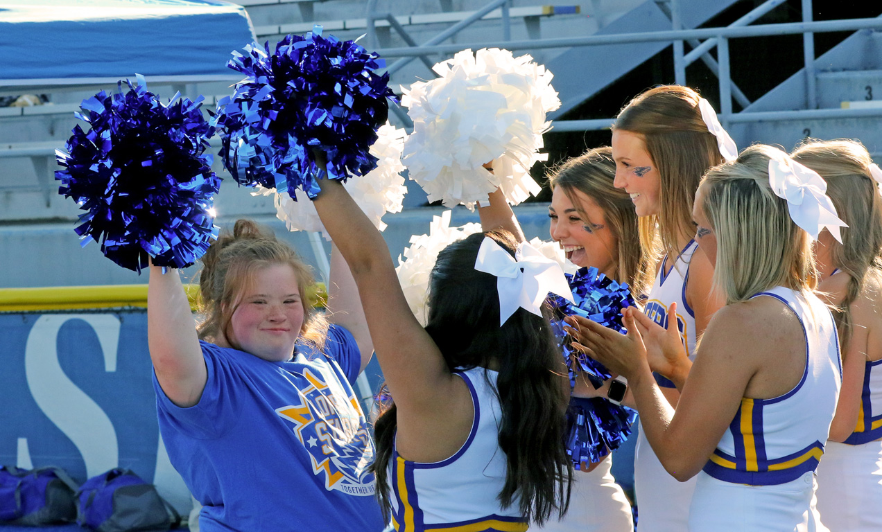 Members of the UNK cheer team interact with a participant during Sunday’s Loper Stars event.
