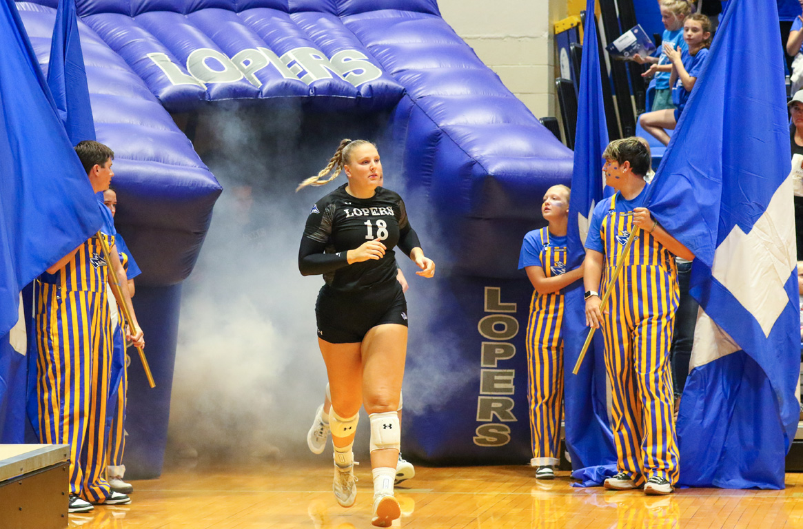 Emersen Cyza leads the Lopers onto the court during Wednesday night’s home match against Peru State College.