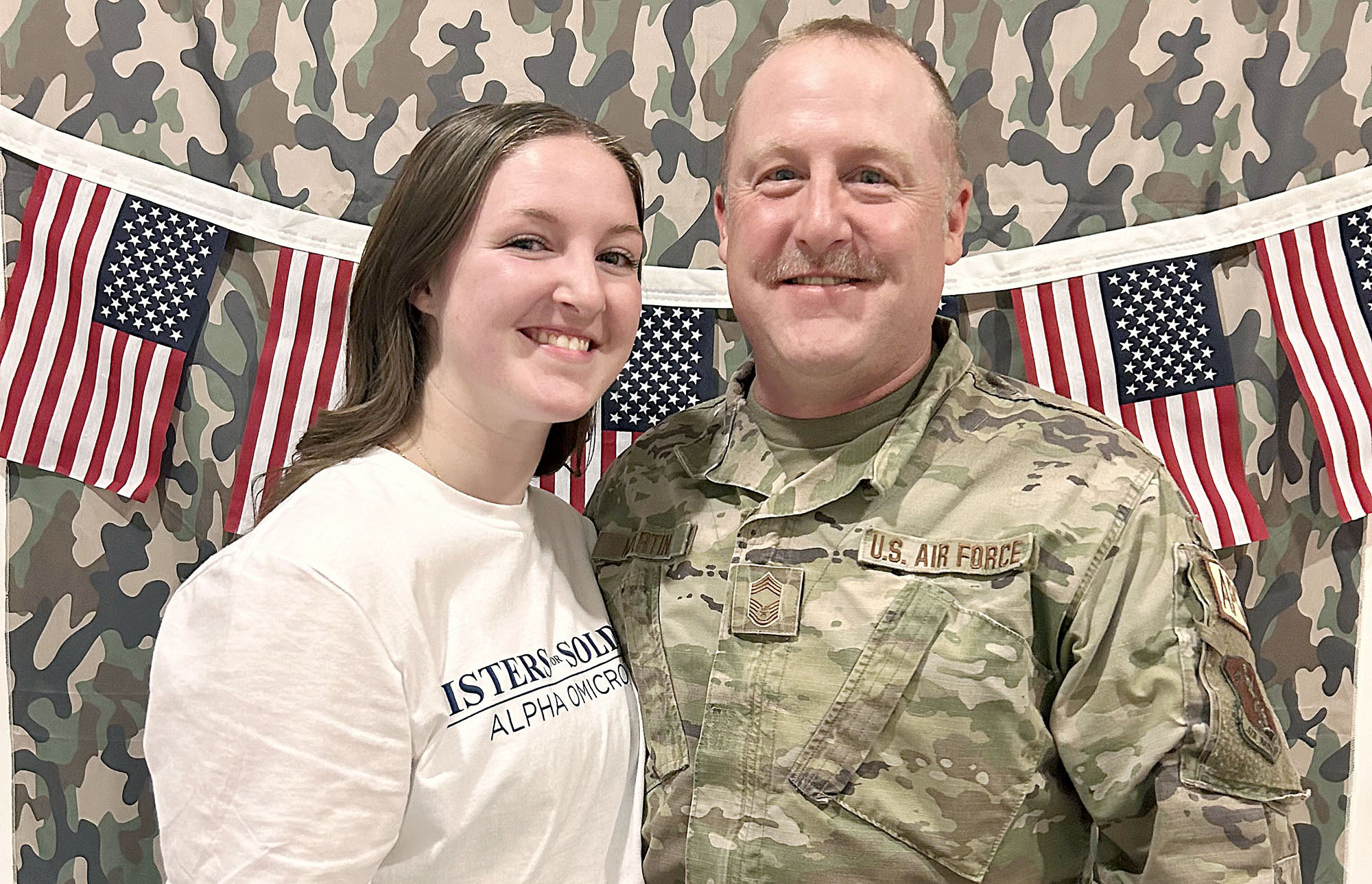 Paiton Martin and her father Chad pose for a photo Tuesday evening during Sisters for Soldiers, an annual event hosted by the Alpha Omicron Pi sorority.
