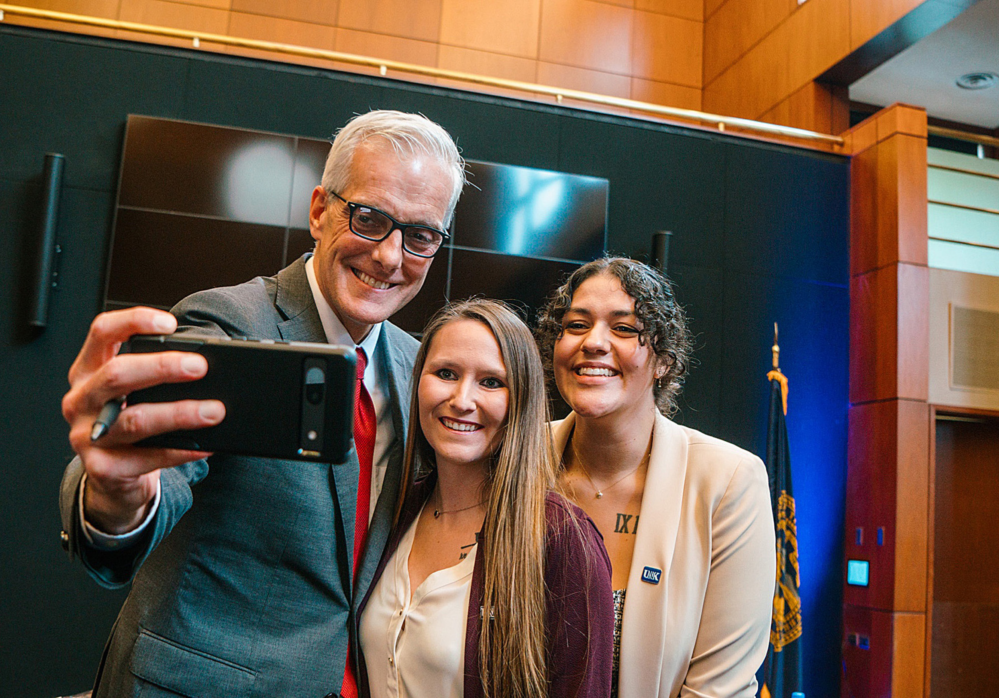 UNK students Courtney Larsen, center, and Tiffany Sauls, right, take a photo with U.S. Secretary of Veterans Affairs Denis McDonough during an event last month.