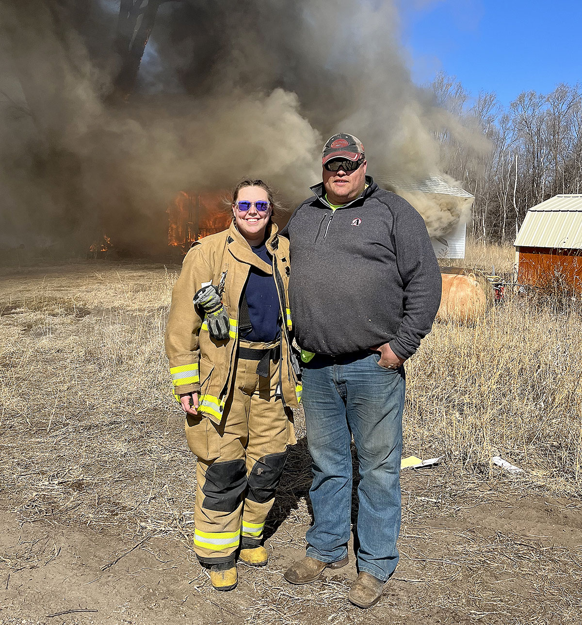 Layce Mayhew and her husband Nathan are both volunteer firefighters with Wood River Fire and Rescue. They’re pictured during a controlled burn. (Courtesy photo)