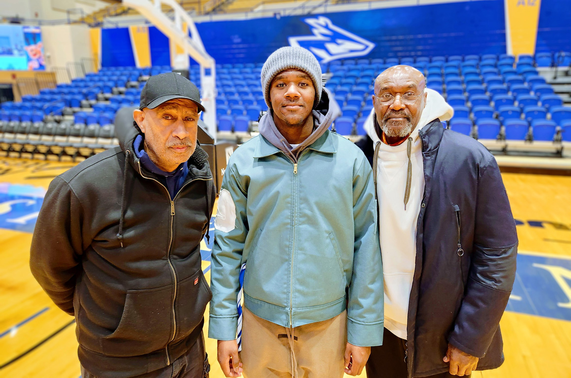 Damiri Lindo, center, is pictured with his father Delroy, right, and uncle Reggie Wilkie following a recent UNK men’s basketball game.