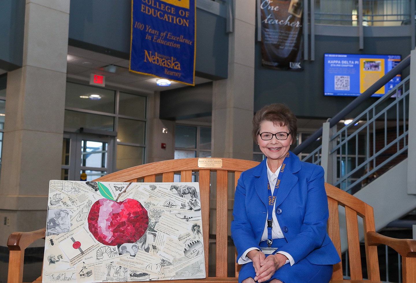 UNK professor of teacher education Jane Ziebarth-Bovill retired last month after a nearly 40-year career in higher education. She’s pictured inside the College of Education building, on a bench that honors her late parents, Wayne and Renee Ziebarth. (Photo by Erika Pritchard, UNK Communications)