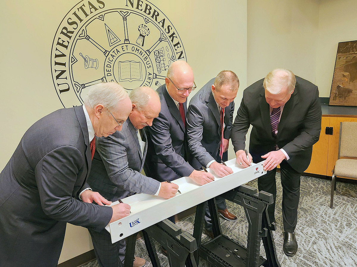 From left, UNMC Chancellor Jeff Gold, Regent Paul Kenney, Sen. John Arch, NU System interim President Chris Kabourek and UNK Chancellor Doug Kristensen sign the steel beam that will top off the new Rural Health Education Building in Kearney.