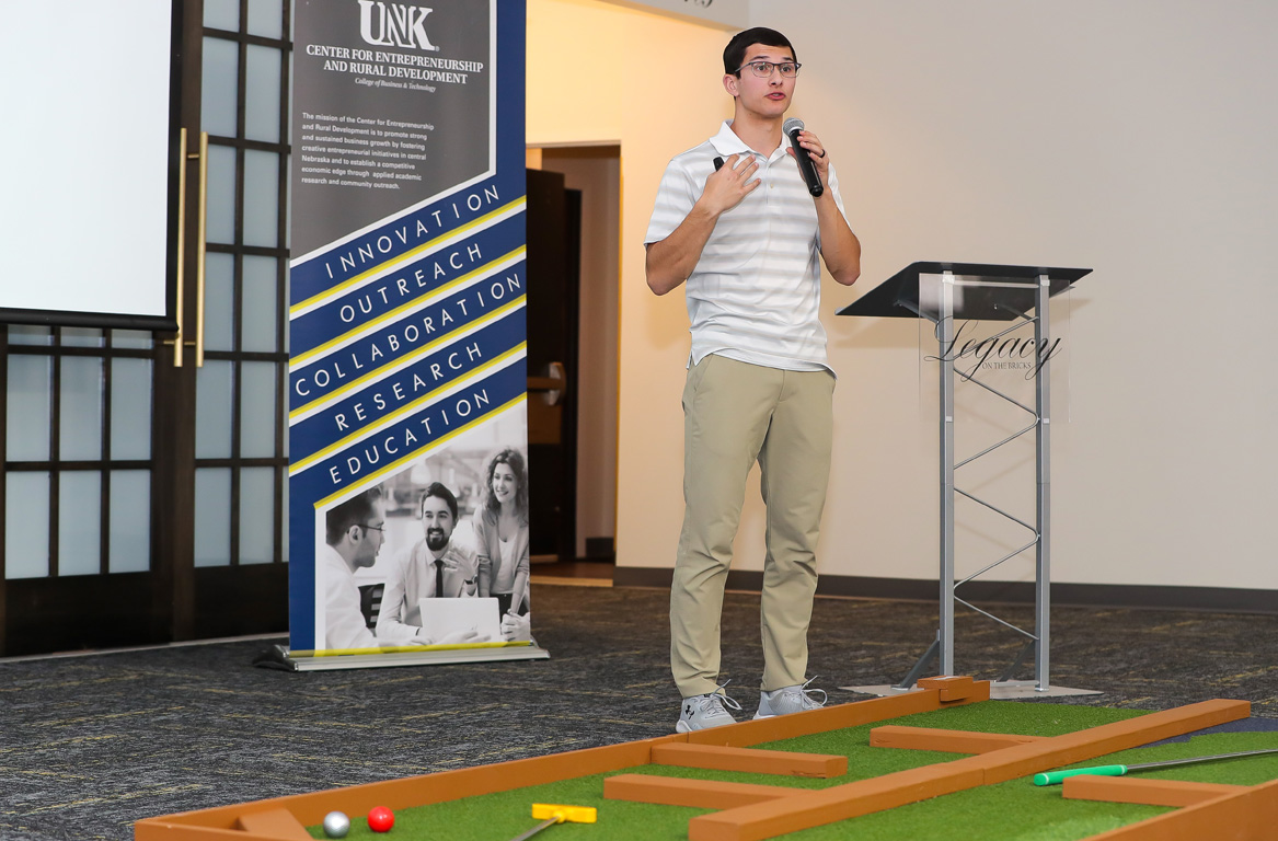 UNK student Zion Moyer pitches his portable miniature golf business Tuesday evening during the Big Idea Kearney competition.