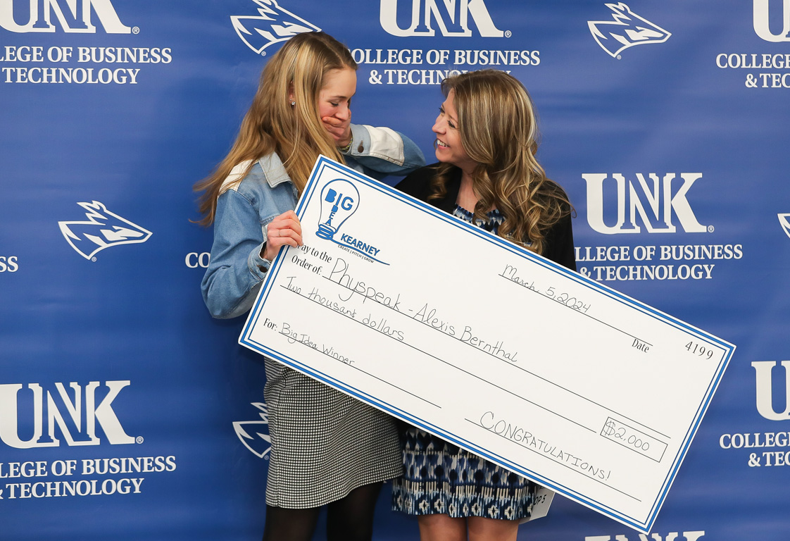 UNK junior Alexis Bernthal, left, is congratulated by Sara Bennett, director of the Center for Entrepreneurship and Rural Development, after winning Tuesday evening’s Big Idea Kearney competition. (Photos by Erika Pritchard, UNK Communications)