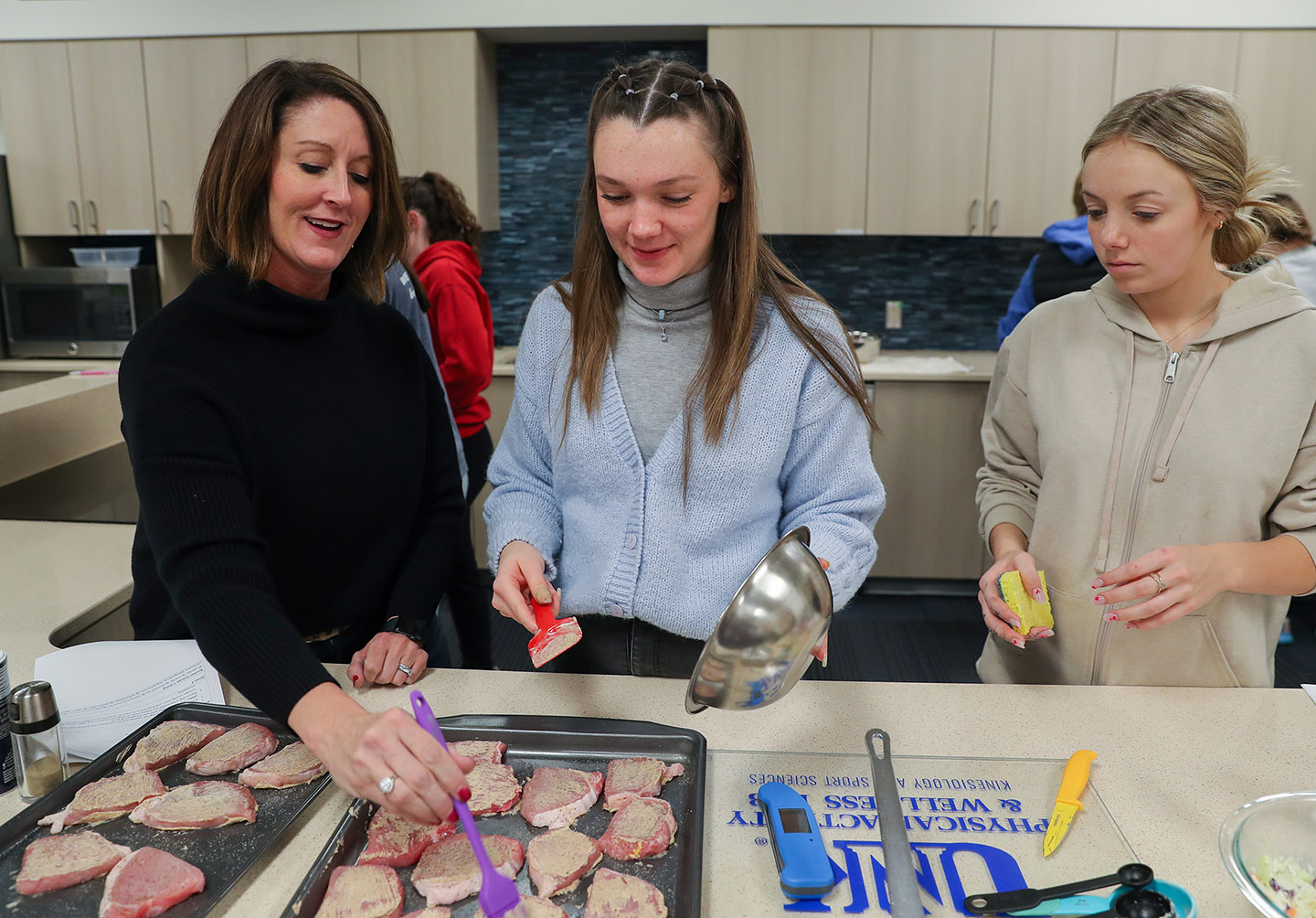 Kaiti George, left, shares her passion for nutrition and dietetics with students at UNK, where she’s a lecturer in the Department of Kinesiology and Sport Sciences.