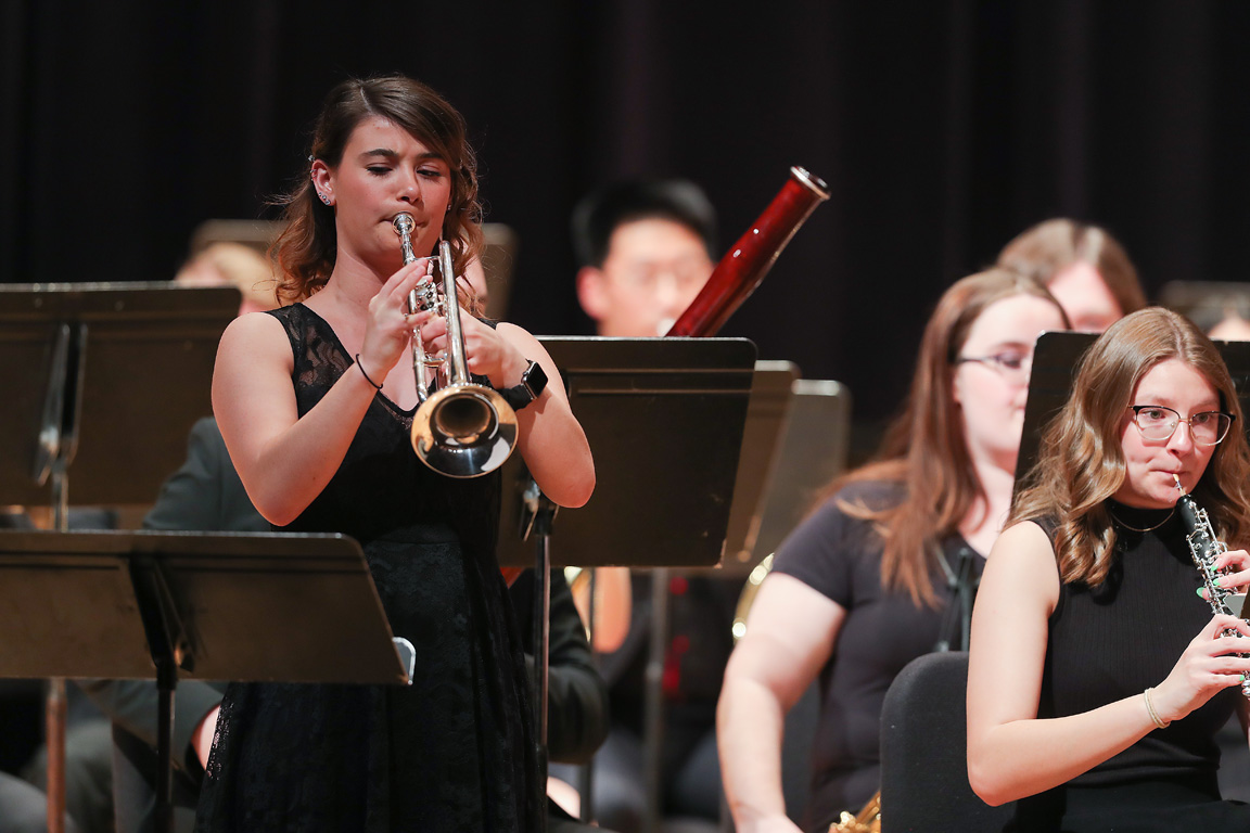 Sadie Uhing, left, performs with the UNK Wind Ensemble during a 2023 concert. She was also part of the Pride of the Plains Marching Band, Jazz/Rock Ensemble, Kappa Kappa Psi honors organization and National Association for Music Education. (Photo by Erika Pritchard, UNK Communications)