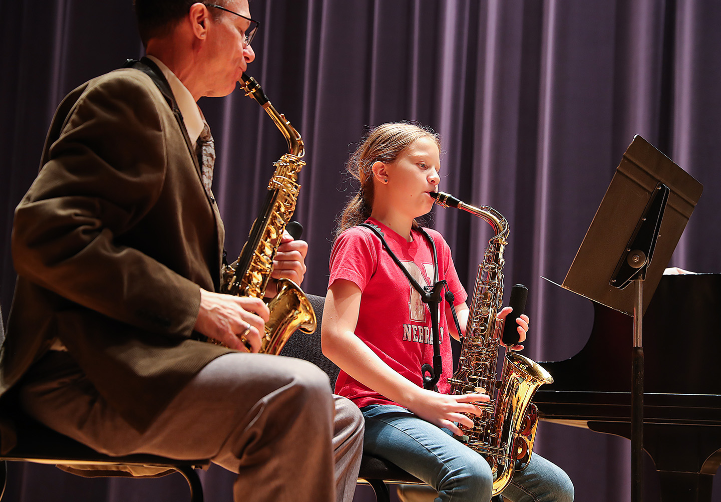 Claire Bahensky plays her one-handed saxophone with guidance from UNK music professor David Nabb in 2022.