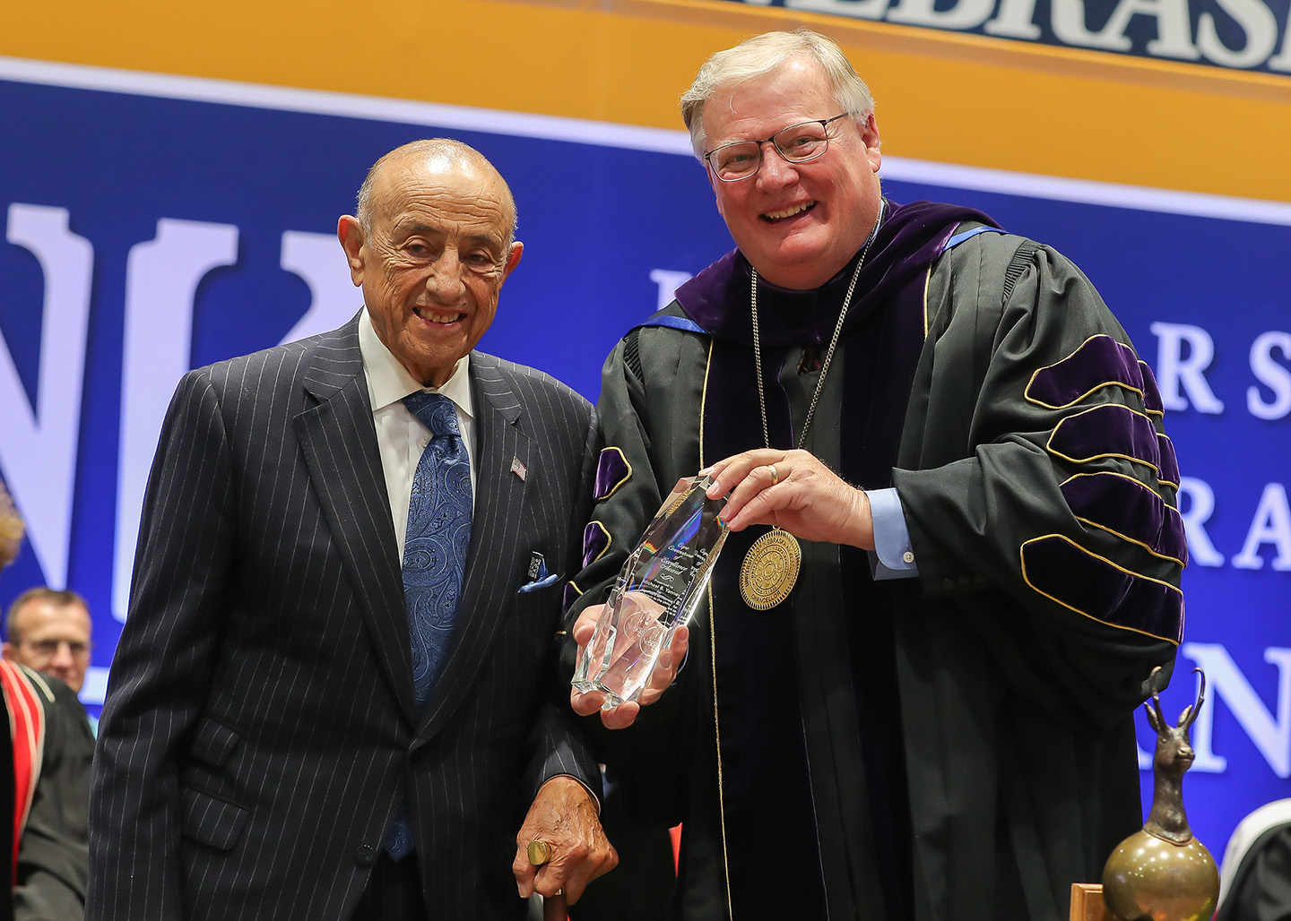 UNK Chancellor Doug Kristensen, right, presents the Ron and Carol Cope Cornerstone of Excellence Award to Michael Yanney during Friday’s spring commencement ceremony at UNK. (Photos by Erika Pritchard, UNK Communications)